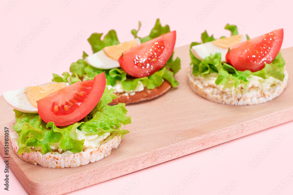Rice Cake Sandwiches with Tomato, Lettuce and Egg on Wooden Cutting Board. Easy Breakfast. Diet Food. Quick and Healthy Sandwiches. Crispbread with Tasty Filling. Healthy Dietary Snack Rice Cake Sandwiches with Tomato, Lettuce and Egg on Wooden Cutting Board. Easy Breakfast. Diet Food. Quick and Healthy Sandwiches. Crispbread with Tasty Filling. Healthy Dietary Snack