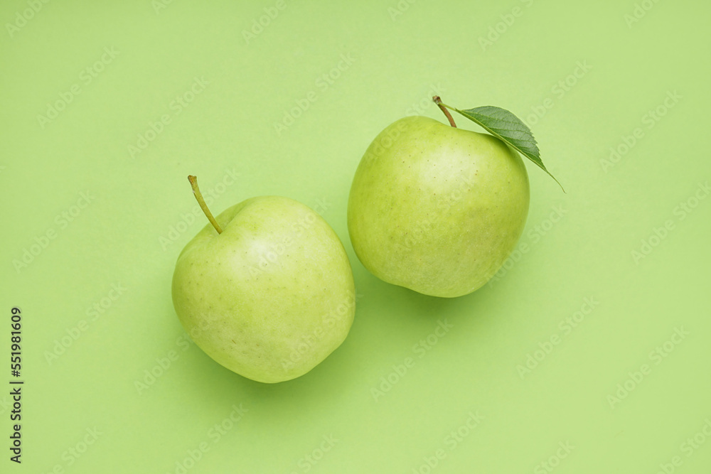 Ripe juicy apples on green background Ripe juicy apples on green background
