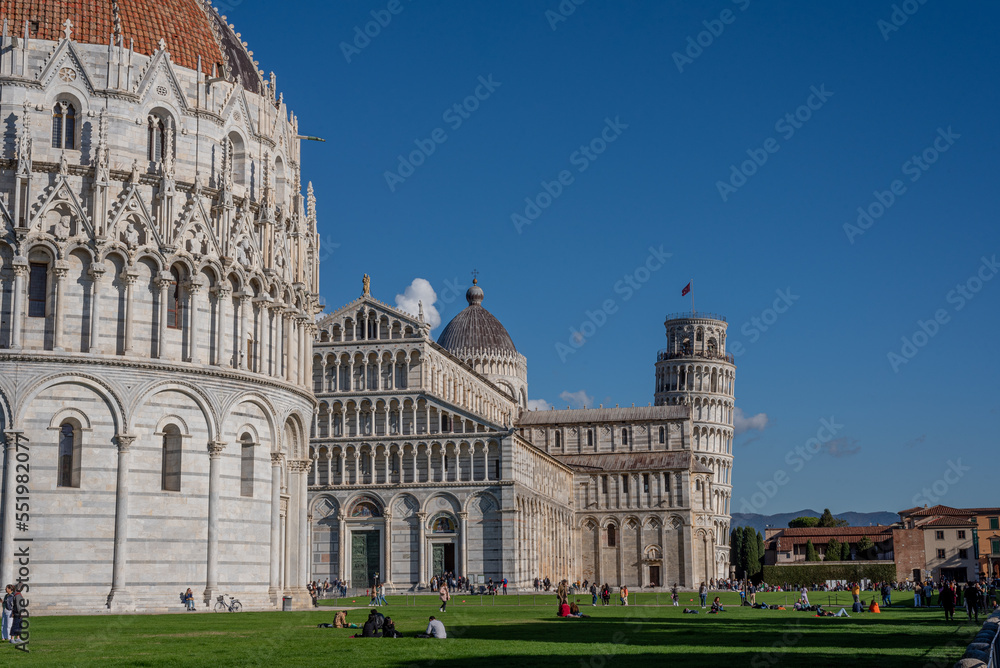 Low angle view of the baptistery, cathedral, Pisa tower and large group of people against sky.