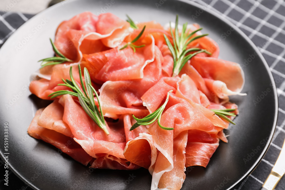Plate with slices of tasty ham on table, closeup