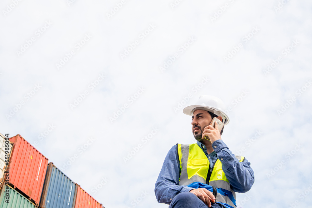 A male specialist engineer is on the phone with an employee of a container shipping company. Logistics global cargo container concept. A male specialist engineer is on the phone with an employee of a container shipping company. Logistics global cargo container concept.