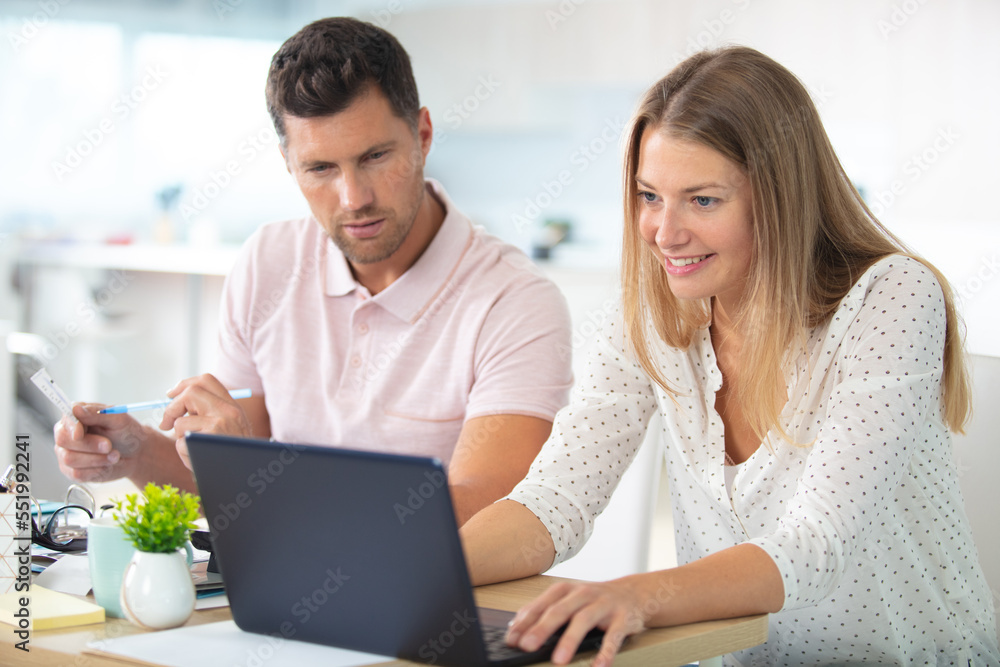 couple with laptop in kitchen couple with laptop in kitchen
