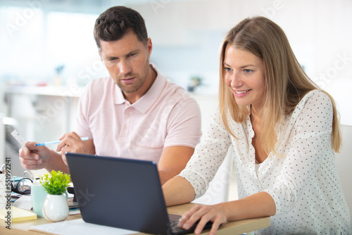 couple with laptop in kitchen