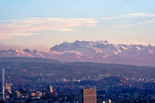 Aerial view over City of Zürich with grain silo and University and Swiss Alps in the background on a sunny autumn evening. Photo taken December 6th, 2022, Zurich, Switzerland. photo