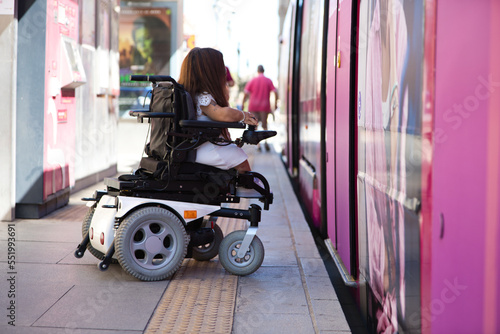 handicapped person getting into a wheelchair on the metro. concept handicapped, social barriers.