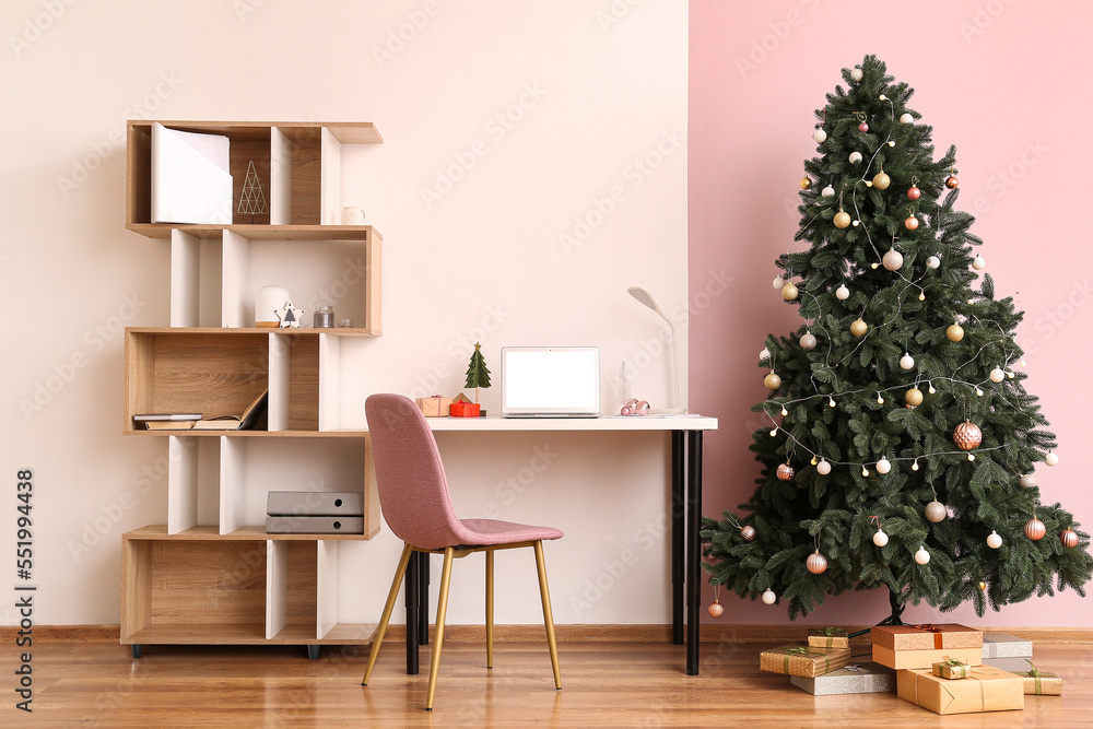 Interior of office with workplace, Christmas tree and presents Interior of office with workplace, Christmas tree and presents