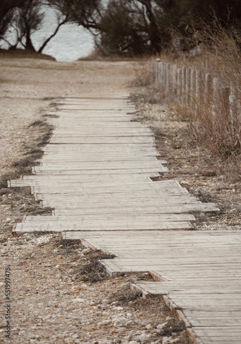 Wooden road to the lake of Luecate. Wooden road to the lake of Luecate.Languedoc-Roussillon, France. Lake of Salses between the departments of Pyrénées-Orientales and Aude in Occitania. photo