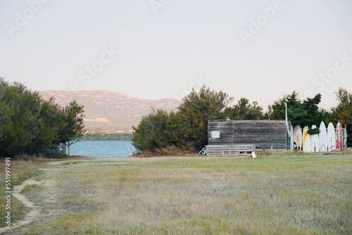 Dirt road to the lake of Luecate, Languedoc-Roussillon, France. Lake of Salses. Natural landscape with windsurfing boards by the lake. photo