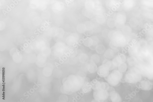 Abstract white bokeh with soft blurred background nature blurry light party in vintage style warm shimmering and faded colorful defocused circular modern. Gray silver shiny copy space for holiday.