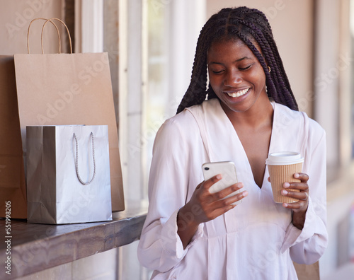 Wall Mural Black woman with smartphone on coffee break after shopping, retail and excited about sale, communication and technology with shopping bags