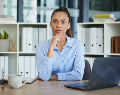 Business woman, thinking and laptop in planning, strategy or design sitting by the desk at the office. Female employee worker contemplating, idea or solution for corporate marketing or project plan