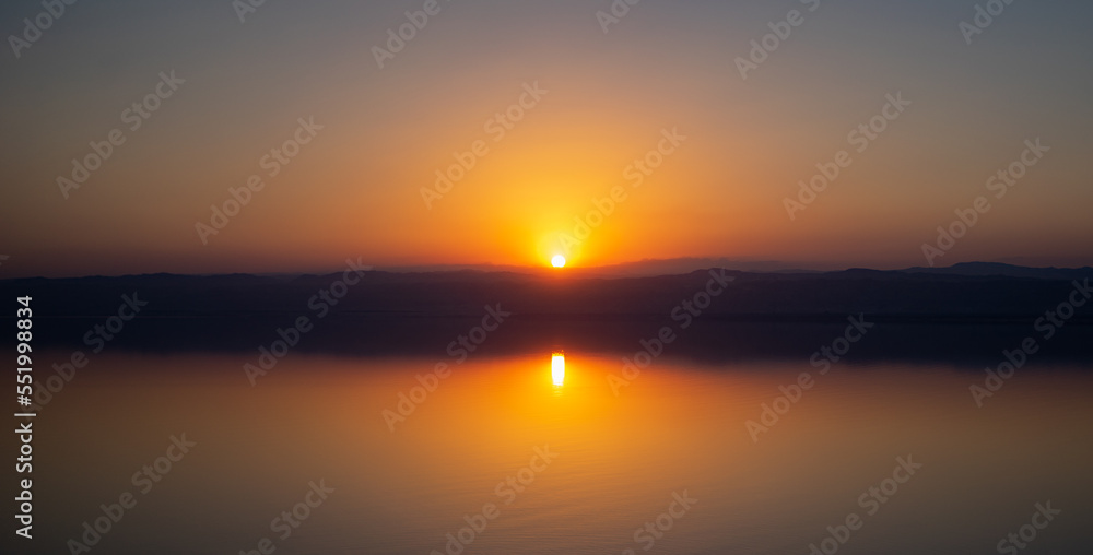 A sunset over the Dead Sea photographed from the Jordanian shore in an evening with high haze A sunset over the Dead Sea photographed from the Jordanian shore in an evening with high haze