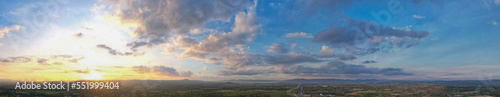 Aerial view of the sunset sky, Panoramic beautiful landscape with twilight sky, Sun bursting through clouds.