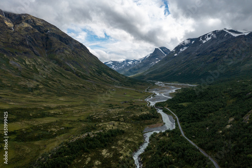 aerial view of norwegian mountain road and river in the mountains