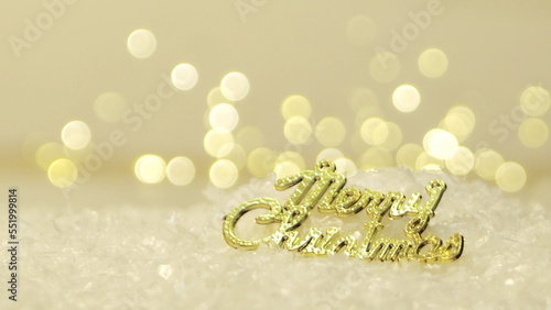 Golden merry christmas text with bokeh lights in the background