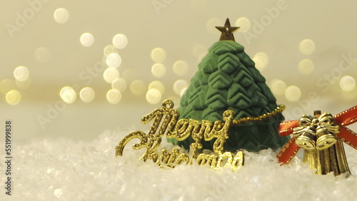 Golden merry christmas text with bokeh lights in the background