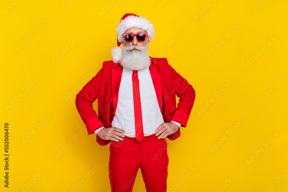 Photo of successful serious aged person put hands waist wear elegant outfit isolated on yellow color background Photo of successful serious aged person put hands waist wear elegant outfit isolated on yellow color background
