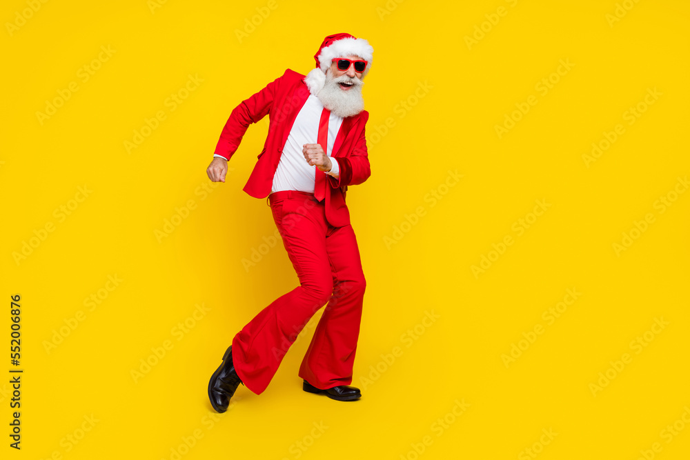 Full length photo of funky cool claus wear red tux costume having fun disco dancing empty space isolated yellow color background Full length photo of funky cool claus wear red tux costume having fun disco dancing empty space isolated yellow color background