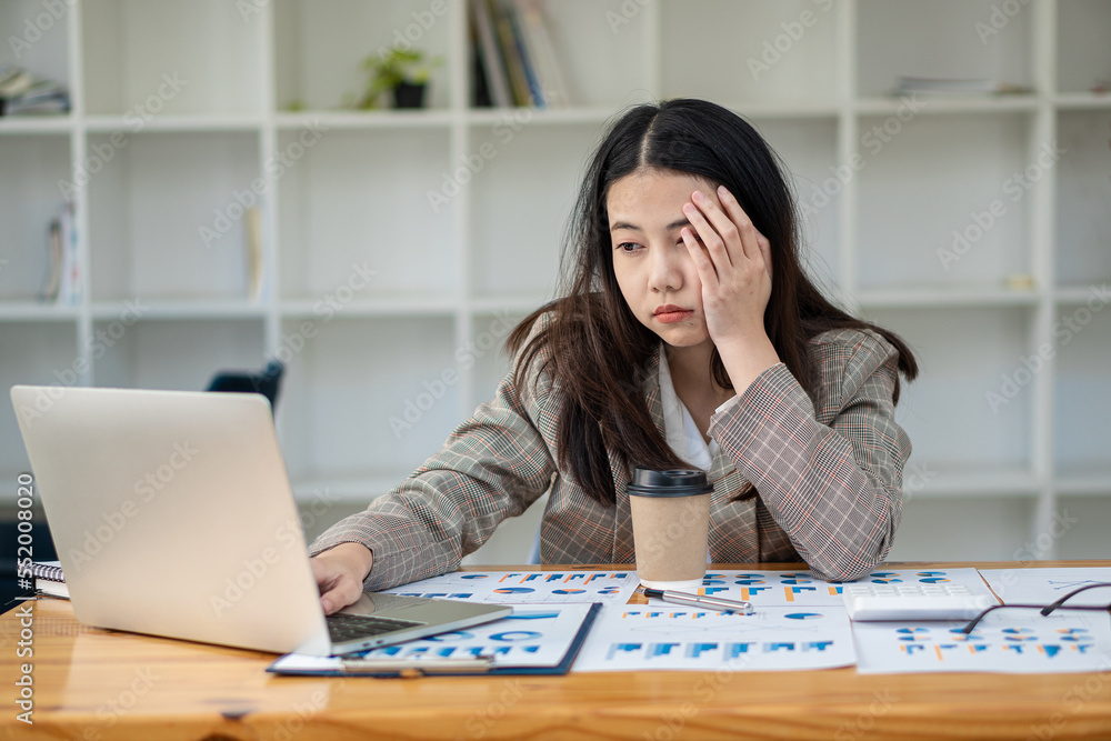 Asian businesswoman working with laptop computer Calculate, analyze, young woman, financial advisor, prepare statistical report, study documents, check financial charts in the office. Asian businesswoman working with laptop computer Calculate, analyze, young woman, financial advisor, prepare statistical report, study documents, check financial charts in the office.