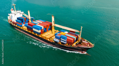 cargo logistics container ship sailing in green sea to import export goods and distributing products to dealer and consumers across worldwide, by container ship Transport business service