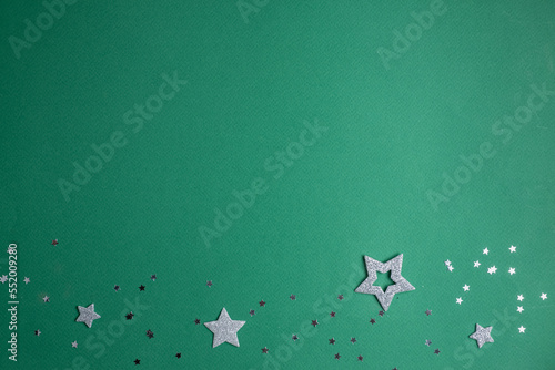 Christmas frame. silver stars on a green background.