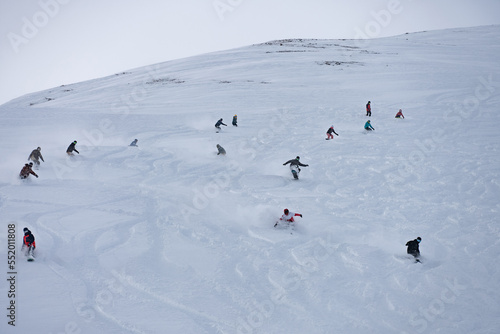 Freeride group in powder, snowboarding in alpes resort in winter. Snowboard freeride i deeep powder snow. Freeride winter in Livigno, Italy.
