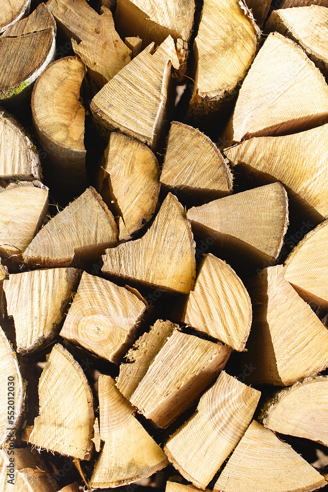 Wall of firewood, background of dry chopped firewood. Wooden background. Natural texture. World energy crisis. Heating with wood. Firewood for fireplace and stove. Wall of firewood, background of dry chopped firewood. Wooden background. Natural texture. World energy crisis. Heating with wood. Firewood for fireplace and stove.