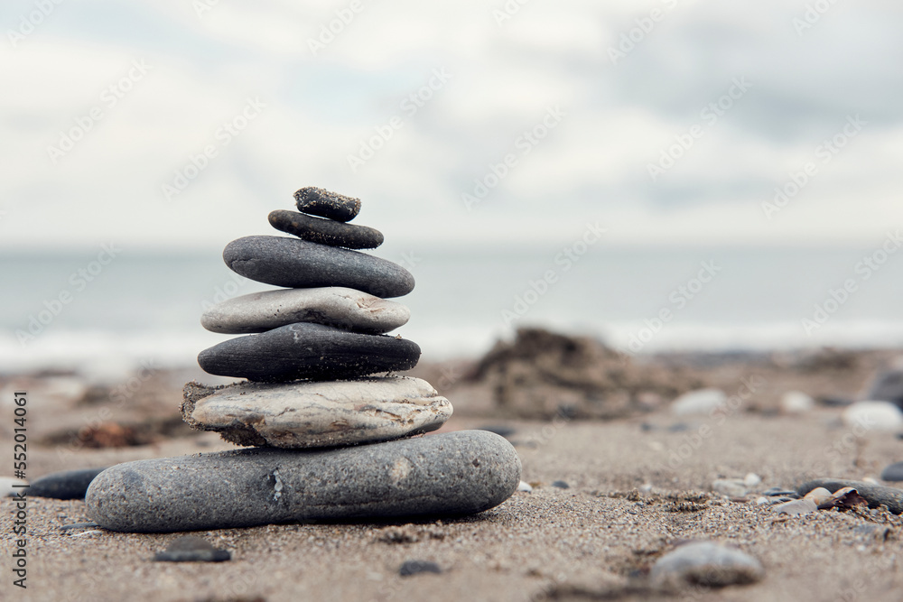 
Zen balancing stones on a cloudy beach