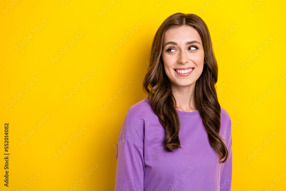 Portrait of cheerful adorable girl beaming smile look interested empty space isolated on yellow color background Portrait of cheerful adorable girl beaming smile look interested empty space isolated on yellow color background