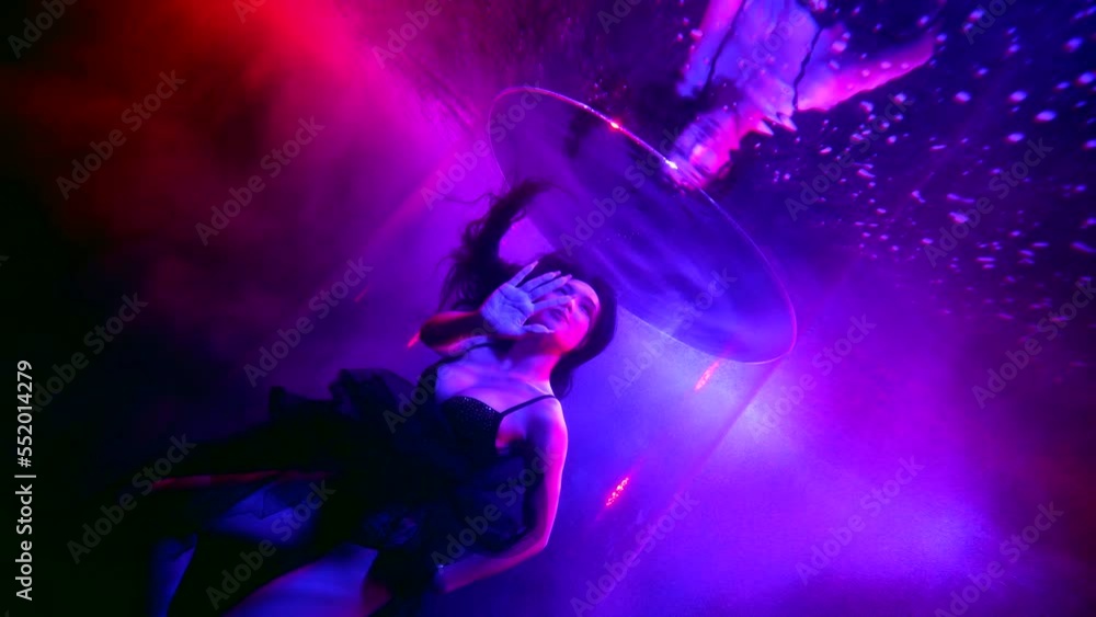 seductive asian woman swimming underwater fashion model in art shooting, colored lights seductive asian woman swimming underwater fashion model in art shooting, colored lights
