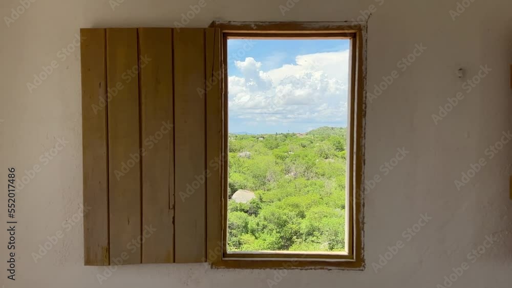 Handheld shot of a handmade wooden window looking out at a green countryside inside of the famous Castle Handheld shot of a handmade wooden window looking out at a green countryside inside of the famous Castle