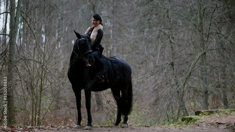 young queen on horseback in royal park, 19 century atmosphere, elegant noblewoman on black stallion young queen on horseback in royal park, 19 century atmosphere, elegant noblewoman on black stallion