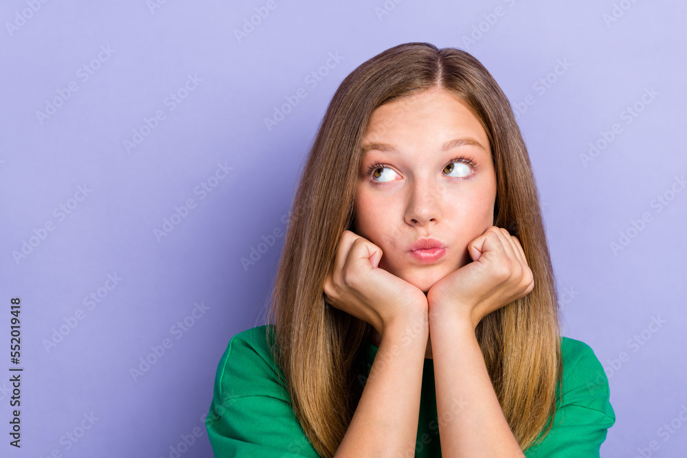 Close up photo portrait of minded cute nice lady schoolkid interested look up empty space isolated on purple color background Close up photo portrait of minded cute nice lady schoolkid interested look up empty space isolated on purple color background