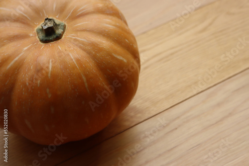 Fresh pale orange pumpkin on wooden backgroud photo