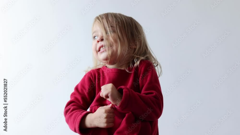 Portrait of cheerful caucasian child girl 3-4 years old showing tongue making faces at camera, fooling around, squint her eyes . Preschool little girl Portrait of cheerful caucasian child girl 3-4 years old showing tongue making faces at camera, fooling around, squint her eyes . Preschool little girl