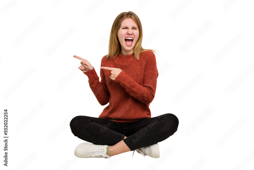 Young caucasian woman sitting on the floor cutout isolated Young caucasian woman sitting on the floor cutout isolated