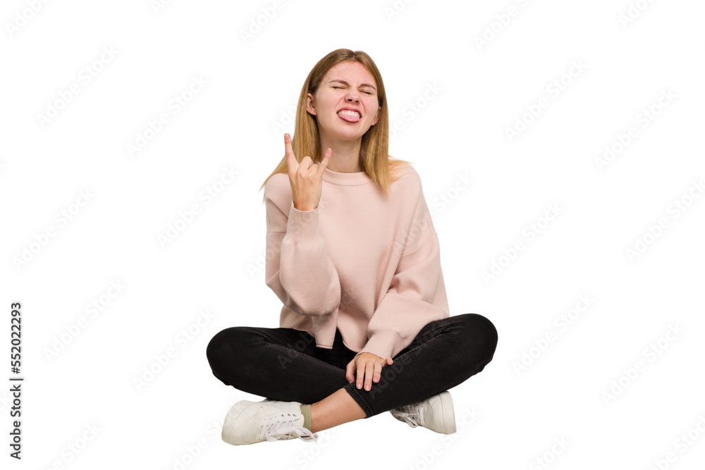 Young caucasian woman sitting on the floor cutout isolated