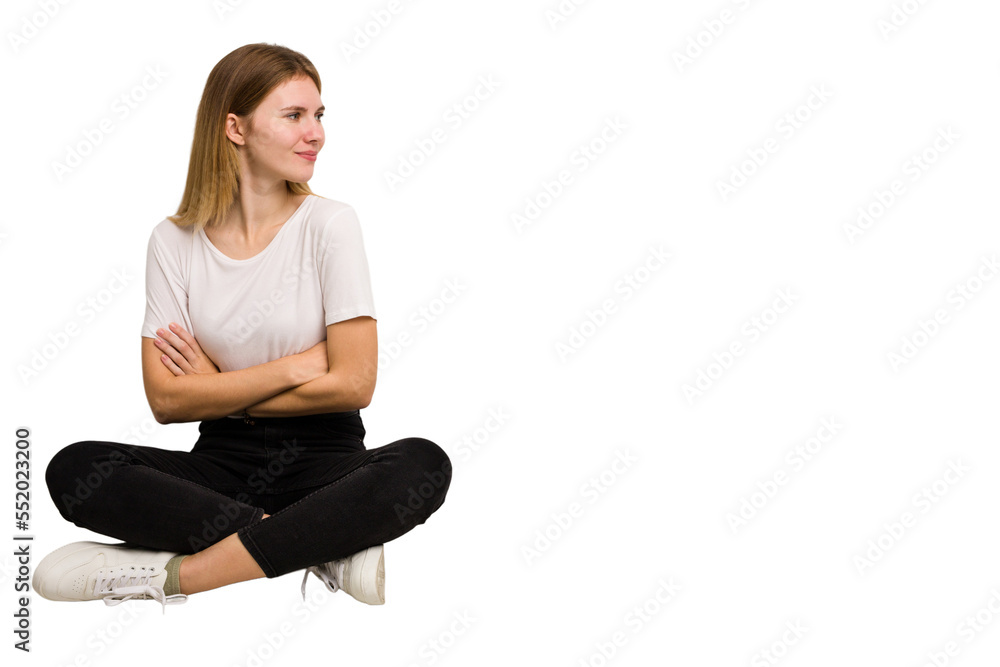 Young caucasian woman sitting on the floor cutout isolated Young caucasian woman sitting on the floor cutout isolated