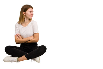 Young caucasian woman sitting on the floor cutout isolated
