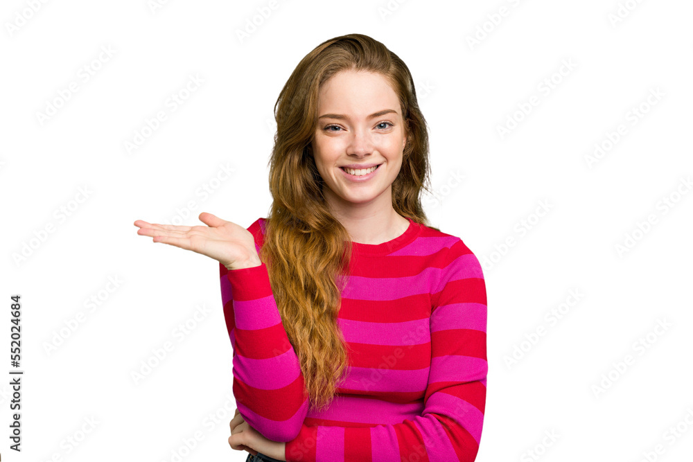 Young caucasian redhead woman isolated showing a copy space on a palm and holding another hand on waist. Young caucasian redhead woman isolated showing a copy space on a palm and holding another hand on waist.