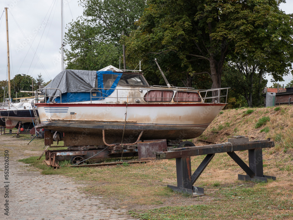 Old weathered boat in a shipyard ready to be restored