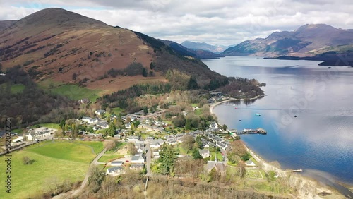 Aerial Angle of Pan Around Village of Luss Loch Lomond Pan From Ben Lomond To Reveal The Village And Valley Behind In Early Spring photo