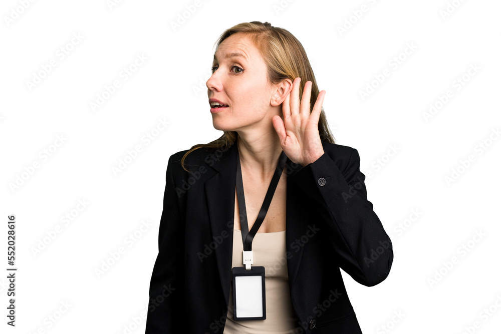 Young caucasian business woman with ID card isolated trying to listening a gossip. Young caucasian business woman with ID card isolated trying to listening a gossip.
