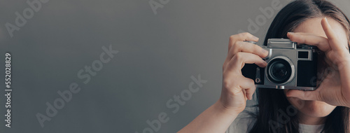 Girl holding an old camera in her hand