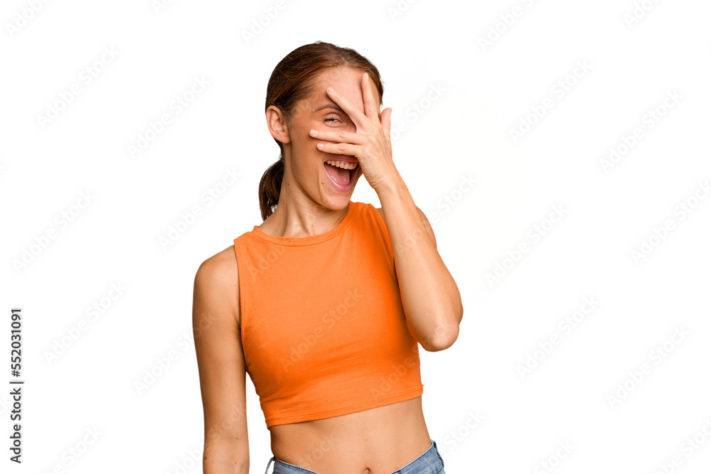 Young caucasian woman isolated blink at the camera through fingers, embarrassed covering face. Young caucasian woman isolated blink at the camera through fingers, embarrassed covering face.
