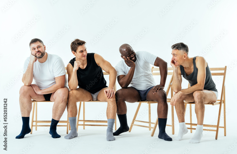 group of multiethnic men posing for a male edition body positive beauty set. Shirtless guys with different age, and body wearing boxers underwear group of multiethnic men posing for a male edition body positive beauty set. Shirtless guys with different age, and body wearing boxers underwear