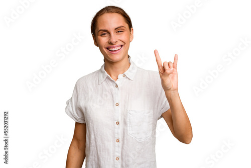 Young caucasian woman isolated showing a horns gesture as a revolution concept.