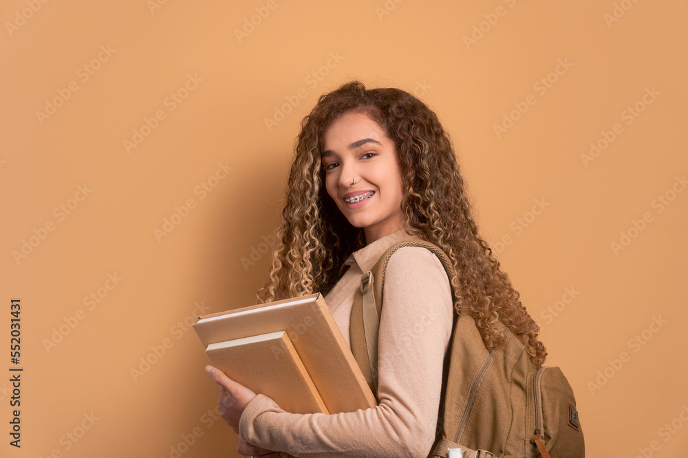 Happy student girl carrying books to class concept Happy student girl carrying books to class concept
