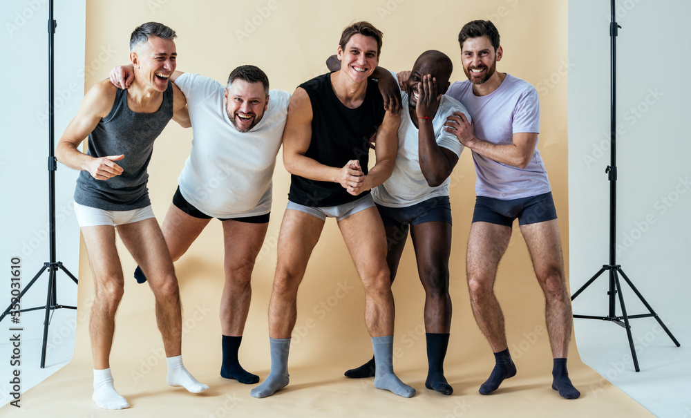 Fototapeta premium group of multiethnic men posing for a male edition body positive beauty set. guys with different age, and body wearing boxers underwear