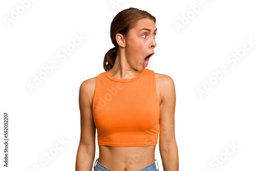 Young caucasian woman isolated being shocked because of something she has seen.